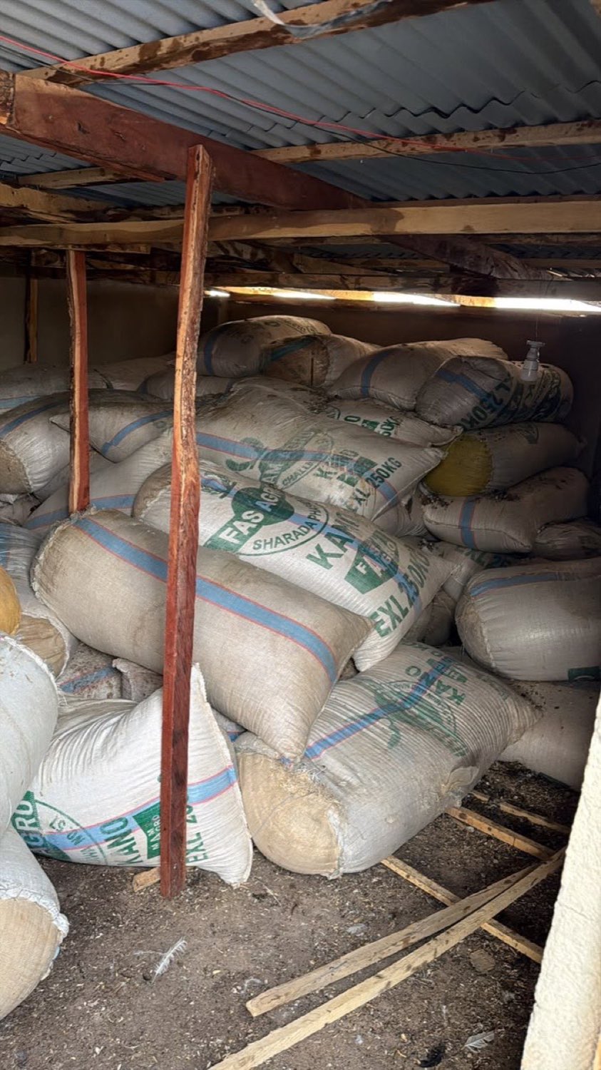 Sacks of feed stacked inside the farm feed store